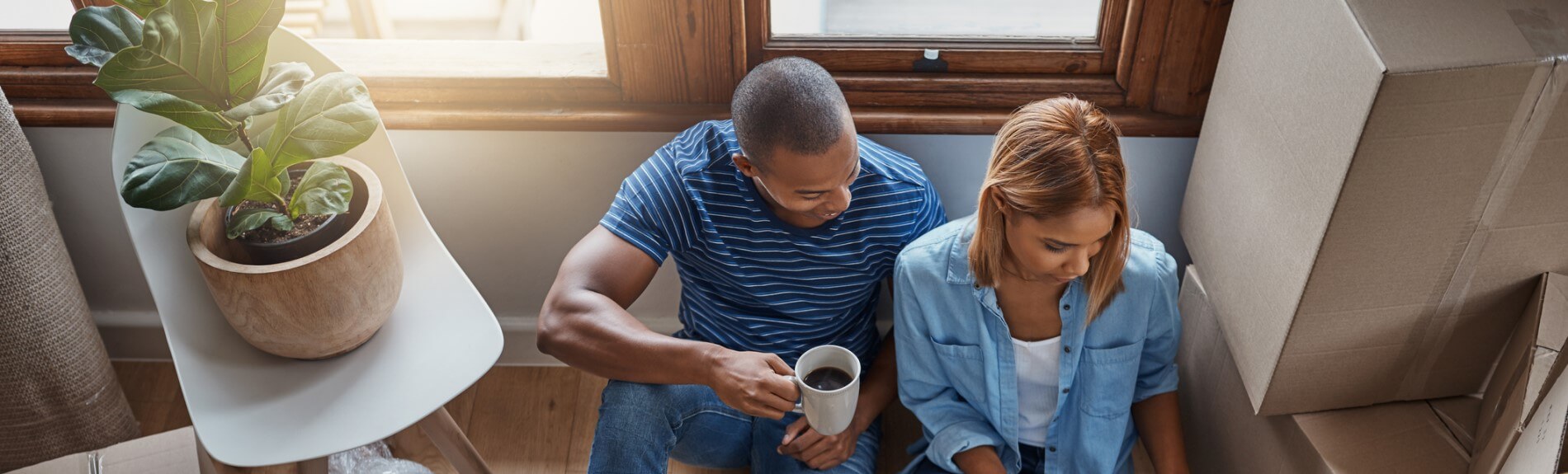 A couple sitting together reviewing information on laptop